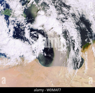 Sandstorms, like this one pictured blowing sand and dust across the Mediterranean Sea from the Libyan Desert on February 10, 2007, are usually the result of atmospheric convection currents, which form when warm, lighter air rises and cold, heavier air sinks. The cold air in this image is visible stretching from the top left side of the image down to the center and swirling back towards the north just above Libya, while the warm air current is seen blowing sand from south to north. (UPI Photo/ESA) Stock Photo