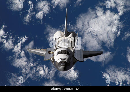 Backdropped by part of Earth, Space Shuttle Discovery (STS-120 ...