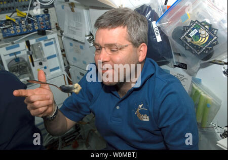 This NASA photo taken by an Astronaut aboard the Space Shuttle Atlantis shows Astronaut Steve Frick, STS-122 commander, eating a snack on the middeck during the second day of the mission on Space Shuttle Atlantis, on February 10, 2008. (UPI Photo/NASA) Stock Photo