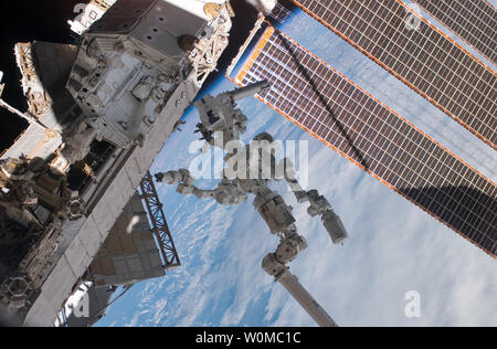 In the grasp of the station's robotic Canadarm2, Dextre (C), also known as the Special Purpose Dextrous Manipulator (SPDM), is featured in this image photographed by a crewmember on the International Space Station while Space Shuttle Endeavour is docked with the station on March 18, 2008. Also pictured are solar array panels (R) and a section of a station truss (L). (UPI Photo/NASA) Stock Photo