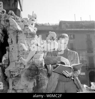 Charlton Heston died at the age of 84 at his home in Beverly Hills on April 5, 2008. He is seen in this file photo circa 1960 going over the script during the filming of 'The Pigeon That Took Rome,' which premiered in 1961.  (UPI Photo/Files) Stock Photo