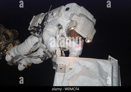 Anchored to a Canadarm2 mobile foot restraint, STS-124 Mission Specialist Ron Garan, takes part in the mission's third spacewalk activities as the space shuttle Discovery is docked to the International Space Station on June 8, 2008. (UPI Photo/NASA/JSC) Stock Photo