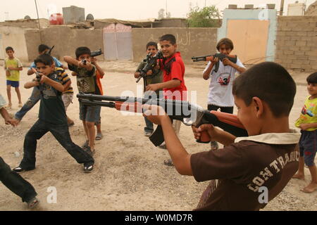 Iraqi boys play with toy guns to celebrate Eid al-Fitr in Baghdad, Iraq on October 3, 2008. Eid al-Fitr, which celebrates the end of the holy month of Ramadan, is the most important date in the Muslim calendar.(UPI Photo/Ali Jasim) Stock Photo