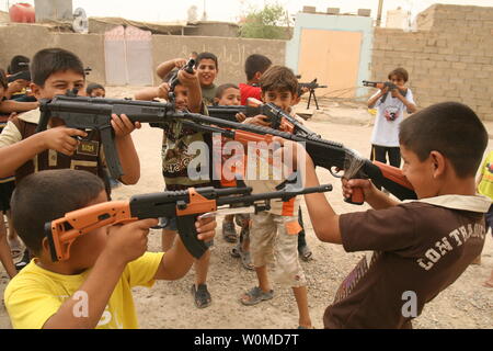 Iraqi boys play with toy guns to celebrate Eid al-Fitr in Baghdad, Iraq on October 3, 2008. Eid al-Fitr, which celebrates the end of the holy month of Ramadan, is the most important date in the Muslim calendar.(UPI Photo/Ali Jasim) Stock Photo