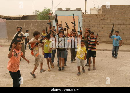 Iraqi boys play with toy guns to celebrate Eid al-Fitr in Baghdad, Iraq on October 3, 2008. Eid Al-Fitr, which celebrates the end of the holy month of Ramadan, is the most important date in the Muslim calendar.(UPI Photo/Ali Jasim) Stock Photo