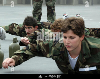 Michael Phelps (L) and members of the U.S. National Swim Team perform an exercise called 'Sharks' at Naval Special Warfare Center at Naval Amphibious Base in Coronado, California on March 19, 2009. The Basic Underwater Demolition/SEAL program is a 6-month training course where more than half the students are eliminated during a rigorous 'Hell Week' and then proceed to diving and land warfare training. (UPI Photo/Blake R. Midnight/U.S. Navy) Stock Photo