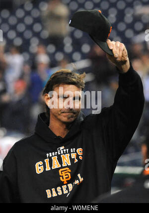 San Francisco Giants pitcher Randy Johnson tips his hat to the crowd with  his son Tanner after he won his 300th victory against the Washington  Nationals in Washington on June 4, 2009.