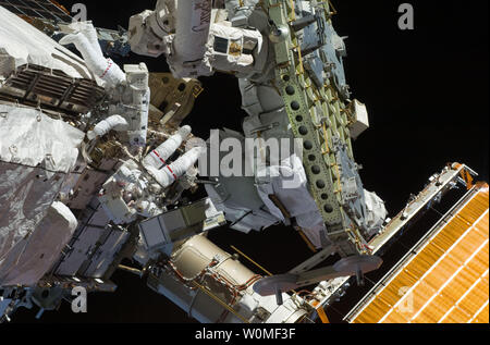 Astronauts Tom Marshburn (upper left) and Christopher Cassidy (seen just below Marshburn), mission specialists for STS-127, share duties on the fourth spacewalk of Endeavour's current mission and its crew's joint activities with the space station. Eleven astronauts and cosmonauts remained inside the International Space Station and the shuttle to which it was docked, while the two continued work on the orbital outpost. The two will team up for the mission's final spacewalk on July 26. (UPI Photo/NASA) Stock Photo