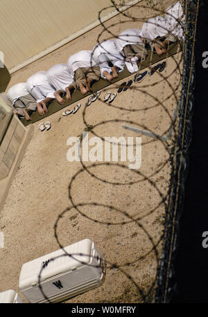 A group of detainees at Joint Task Force Guantanamo (JTF) bow and touch the forehead to the ground as they observe morning prayer before sunrise inside Camp Delta on October 28, 2009. Detainees at the JTF are afforded the opportunity to pray five times each day and are provided prayer rugs and copies of the Quran. UPI/Marcos T. Hernandez/U.S. Navy Stock Photo