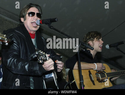 Billy Ray Cyrus (L) performs for the Airmen, Soldiers, Sailors and Marines of Bagram Airfield during a USO tour in Afghanistan on December 15, 2009. Cyrus, Dave Attell, Anna Kournikova and Nick Bollettieri attended the USO tour to boost the morale of the service members. UPI/Felicia Juenke/U.S. Air Force Stock Photo