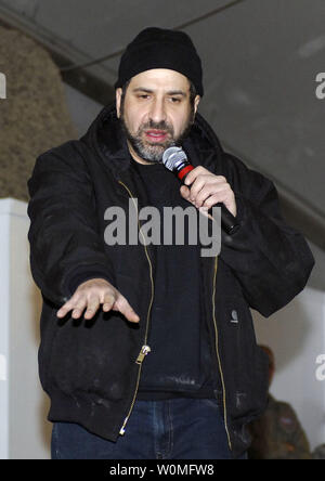 Comedian Dave Attell entertains the Airmen, Soldiers, Sailors and Marines of Bagram Airfield during a USO tour in Afghanistan on December 15, 2009. Attell, Billy Ray Cyrus, Anna Kournikova and Nick Bollettieri attended the USO tour to boost the morale of the service members. UPI/Felicia Juenke/U.S. Air Force Stock Photo