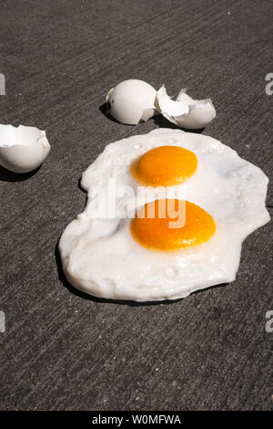 The expression 'it's hot enough to fry eggs on a sidewalk' is used during a heatwave, USA Stock Photo