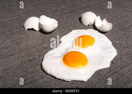 The expression 'it's hot enough to fry eggs on a sidewalk' is used during a heatwave, USA Stock Photo