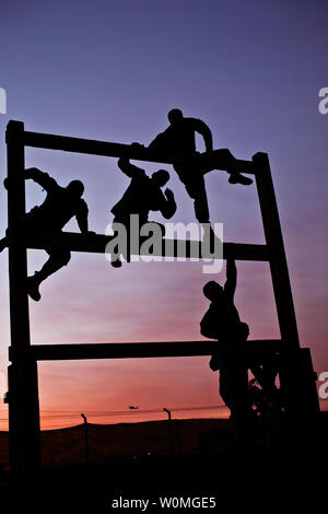 Soldiers from Company F, 3rd Battalion, 227th Aviation Regiment, 1st Air Cavalry Brigade, 1st Cavalry Division, U.S. Division Center, climb through an obstacle course at sunrise at Camp Taji, Iraq on March 23, 2010. UPI/Travis Zielinski/U.S. Air Force Stock Photo