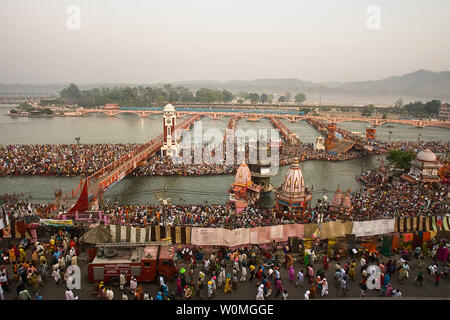 Hindu devotees line up to take a holy bath in the Ganges River during the Kumbha Mela festival in Haridwar, India on April 15, 2010.  The pilgrimage takes place every three years, rotating amongst four different locations in India, thus, once every 12 years in each location.  It lasts for 42 days attracting millions of people, and this year ends on April 28, 2010.   Devotees believe that taking a bath in the river will wash their sins away so they begin life anew.    UPI/Maryam Rahmanian Stock Photo
