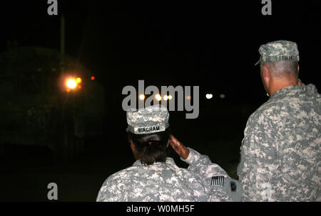 Brig. Gen. Nick Tooliatos (R) and Col. Gwendolyn Bingham, of the 1st Theater Sustainment Command, salute soldiers from the 4th Stryker Brigade Combat Team, 2nd Infantry Division as they convoy into Kuwait in the early morning hours of August 19, 2010. The 4/2 convoyed their own vehicles out of Iraq after a year-long tour there, bringing troop levels in the country closer to the 50,000 mark. UPI/Natalie Cole/U.S. Army Stock Photo