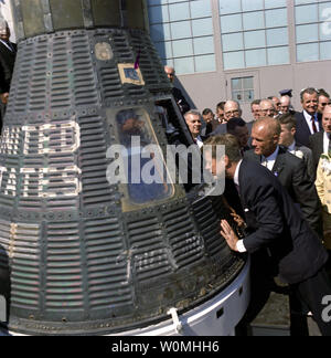 This photograph, part of the John F. Kennedy Presidential Library, taken on February 23, 1962 shows President John F. Kennedy peering into a space capsule at the presentation ceremony of NASA Distinguished Service Medal (DSM) to Astronaut and Colonel John Glenn, Jr. at Cape Canaveral, Florida. This image is one of the more than 1,500 images that the National Archives has released in their 'Access to a Legacy' project, which is an online digital archive of high interest material from President John F. Kennedy's official and personal records. The collection consist of photographs, audio recordin Stock Photo