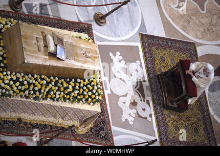 Pope Benedict XVI kneels before the coffin of his predecessor Pope John Paul II in St. Peter's Basilica in the Vatican following his beatification on May 1, 2011.   UPI/Stefano Spaziani Stock Photo