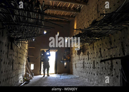 US Army Sgt. 1st Class Jeffrey Cesaitis secures a grape drying house before members of Provincial Reconstruction Team Zabul and the U.S. Department of Agriculture enter during a visit to a village near the city of Qalat, Zabul province, Afghanistan, May 8, 2011. UPI/DOD Stock Photo