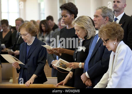 In this image released by the Gerald R. Ford Library and Museum, from left, former first lady Rosalynn Carter, first lady Michelle Obama, former first lady and Secretary of  State Hillary Rodham Clinton, former President George W. Bush, and former first lady Nancy Reagan, attend the funeral of former first lady Betty Ford at St. Margaret's Episcopal Church, July 12, 2011, in Palm Desert, California. UPI/Gerald R. Ford Library and Museum/David Hume Kennerly Stock Photo