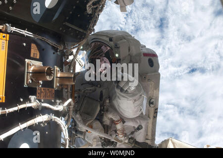 This NASA image taken on July 12, 2011 shows NASA astronaut Mike Fossum, Expedition 28 flight engineer, as he waits at an International Space Station's pressurized mating adapter (PMA-2) docked to the space shuttle Atlantis, as the station's robotic system moves the failed pump module (out of frame) over to the spacewalking astronaut and the shuttle's cargo bay. Fossum and crewmate Ron Garan sent six hours and 31 minutes on their July 12 spacewalk. Space Shuttle Atlantis is at the International Space Station on mission STS-135, the final shuttle mission.  UPI/NASA Stock Photo