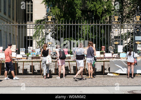 Berlin, Germany - May,  2019:  People looking at second hand books for sale on flea market in front of the Humboldt University in Berlin, Germany Stock Photo