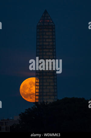 A supermoon rises behind the Washington Monument, June 23, 2013, in Washington. This year the Supermoon is up to 13.5% larger and 30% brighter than a typical Full Moon is. This is a result of the Moon reaching its perigree - the closest that it gets to the Earth during the course of its orbit. During perigree on 23 June the Moon was about 221,824 miles away, as compared to the 252,581 miles away that it is at its furthest distance from the Earth (apogee). Photo Credit: UPI/Bill Ingalls/NASA Stock Photo