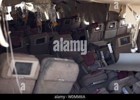 In this photo provided by the National Transportation Safety Board, NTSB investigators survey the interior view of  the wreckage of Asiana Flight 214, in San Francisco, California on July 7, 2013. The Boeing 777 was en route from Shanghai with a layover in Seoul, South Korea, carrying 291 passengers. Two people died and more than 180 were injured. Pilot Lee Kang-kook had logged more than 9,000 hours on various aircraft, but only 43 hours on the Boeing 777 and was considered still in training on that aircraft.   UPI.... Stock Photo