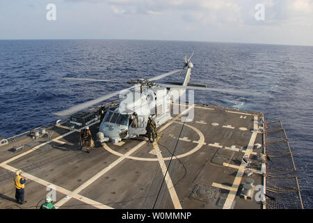 A U.S. Navy MH-60R Sea Hawk helicopter from Helicopter Maritime Strike Squadron (HSM) 78, Det 2, assigned to the guided-missile Destroyer USS Pinckney (DDG 91), lands aboard Pinckney during a crew swap before returning on task in the search and rescue for the missing Malaysian airlines flight MH370, May 10, 2014. The flight had 227 passengers from 14 nations, mainly China, and 12 crew members. According to the Malaysia Airlines website, three Americans, including one infant, were also aboard. UPI/Chris D. Boardman/US Navy Stock Photo