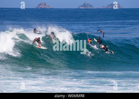 Rio de Janeiroi, Brazil - August 13, 2016: amateur surfers having fun on a swell day at arpoador beach, Rio de Janeiro. Stock Photo