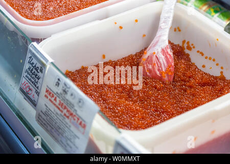Containers with fresh, pink fish eggs for sale. Market hall in  Petropavlovsk-Kamchatsky, Russia Stock Photo - Alamy