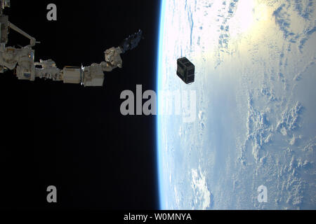 Expedition 46 flight engineer Tim Peake of ESA captured this photo on January 29, 2016 from the International Space Station, as the robotic arm in Japan's Kibo laboratory successfully deployed two combined satellites from Texas universities. The pair of satellites -- AggieSat4 built by Texas A&M University students, and BEVO-2 built by University of Texas students -- together form the Low Earth Orbiting Navigation Experiment for Spacecraft Testing Autonomous Rendezvous and Docking (LONESTAR) investigation...The satellites will demonstrate communication protocols between them and with ground st Stock Photo