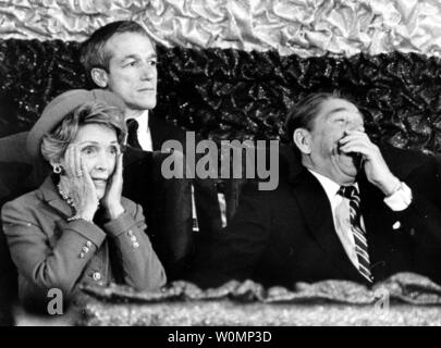 In this file photo, President Ronald Reagan roars with laughter as First Lady Nancy Reagan realizes she has forgotten to introduce him after she spoke to an inaugural tribute at the Capital Centre during President Reagan's second inauguration on January 21, 1985.   Former first lady Nancy Reagan died at her home in Los Angeles at 94 on March 6, 2016.   File photo by Pat Benic/UPI Stock Photo