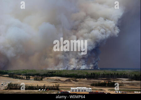 Aerial view of the wildfires in the Fort McMurray area from a CH-146 Griffon on May 4, 2016. The Canadian Armed Forces have deployed air assets to the area to support the Province of Alberta's emergency response efforts. At the time this image was taken, a mandatory evacuation had been placed on all of Fort McMurray - the largest evacuation on record in Canada. The fire had burned through nearly 77 square kilometers, razing neighborhoods across the city. Photo by MCpl VanPutten/Canadian Armed Forces/UPI Stock Photo