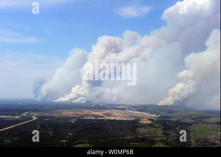 Aerial view of the wildfires in the Fort McMurray area from a CH-146 Griffon on May 4, 2016. The Canadian Armed Forces have deployed air assets to the area to support the Province of Alberta's emergency response efforts. At the time this image was taken, a mandatory evacuation had been placed on all of Fort McMurray - the largest evacuation on record in Canada. The fire had burned through nearly 77 square kilometers, razing neighborhoods across the city. Photo by MCpl VanPutten/Canadian Armed Forces/UPI Stock Photo