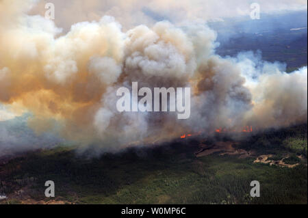 Aerial view of the wildfires in the Fort McMurray area from a CH-146 Griffon on May 4, 2016. The Canadian Armed Forces have deployed air assets to the area to support the Province of Alberta's emergency response efforts. At the time this image was taken, a mandatory evacuation had been placed on all of Fort McMurray - the largest evacuation on record in Canada. The fire had burned through nearly 77 square kilometers, razing neighborhoods across the city. Photo by MCpl VanPutten/Canadian Armed Forces/UPI Stock Photo