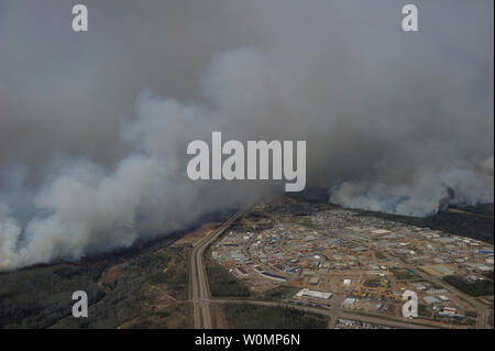 Aerial view of the wildfires in the Fort McMurray area from a CH-146 Griffon on May 4, 2016. The Canadian Armed Forces have deployed air assets to the area to support the Province of Alberta's emergency response efforts. At the time this image was taken, a mandatory evacuation had been placed on all of Fort McMurray - the largest evacuation on record in Canada. The fire had burned through nearly 77 square kilometers, razing neighborhoods across the city. Photo by MCpl VanPutten/Canadian Armed Forces/UPI Stock Photo