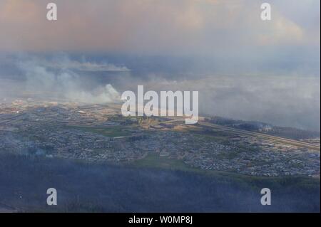 Aerial view of Fort McMurray taken from a CH-146 Griffon helicopter on May 5, 2016. The Canadian Armed Forces have air assets deployed in support of the Province of Alberta's wildfire emergency response efforts. At the time this image was taken, a mandatory evacuation had been placed on all of Fort McMurray - the largest evacuation on record in Canada. The fire had burned through nearly 77 square kilometers, razing neighborhoods across the city. Photo by MCpl VanPutten/Canadian Armed Forces/UPI Stock Photo