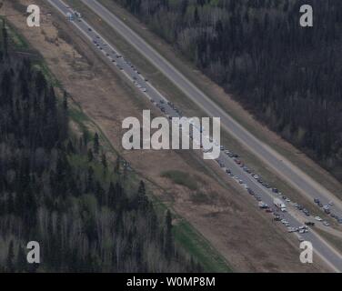 Aerial view of highway 63, south of Fort McMurray, taken from a CH-146 Griffon helicopter on May 5, 2016. The Canadian Armed Forces have air assets deployed in support of the Province of Alberta's wildfire emergency response efforts. At the time this image was taken, a mandatory evacuation had been placed on all of Fort McMurray - the largest evacuation on record in Canada. The fire had burned through nearly 77 square kilometers, razing neighborhoods across the city. Photo by MCpl VanPutten/Canadian Armed Forces/UPI Stock Photo