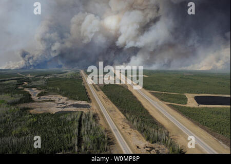Aerial view of highway 63, south of Fort McMurray, taken from a CH-146 Griffon helicopter on May 5, 2016. The Canadian Armed Forces have air assets deployed in support of the Province of Alberta's wildfire emergency response efforts. At the time this image was taken, a mandatory evacuation had been placed on all of Fort McMurray - the largest evacuation on record in Canada. The fire had burned through nearly 77 square kilometers, razing neighborhoods across the city. Photo by MCpl VanPutten/Canadian Armed Forces/UPI Stock Photo