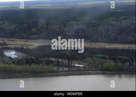 Aerial view of highway 63, south of Fort McMurray, taken from a CH-146 Griffon helicopter on May 5, 2016. The Canadian Armed Forces have air assets deployed in support of the Province of Alberta's wildfire emergency response efforts. At the time this image was taken, a mandatory evacuation had been placed on all of Fort McMurray - the largest evacuation on record in Canada. The fire had burned through nearly 77 square kilometers, razing neighborhoods across the city. Photo by MCpl VanPutten/Canadian Armed Forces/UPI Stock Photo