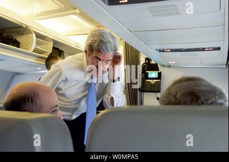 U.S. Secretary of State John Kerry talks with State Department Special Envoy for Israeli-Palestinian Negotiations Frank Lowenstein and National Security Council Senior Director for Counter-ISIL Operations Robert Malley aboard his aircraft on May 10, 2016, en route from LeBourget Airport in Paris, France, to London Stansted Airport. Kerry traveled to the UK for a series of bilateral meetings, an appearance at Oxford University, and his attendance at an anti-corruption meeting hosted by British Prime Minister David Cameron. Photo by U.S. Department of State/UPI