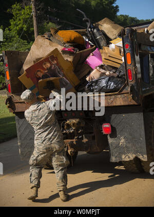 Tech. Sgt. Brian Grim of the 167th Airlift Wing, Martinsburg, W.Va., picks up debris on June 26, 2016, in Clendenin, West Virginia. The June 23, 2016 flood was described as a once in 1000 year event leading W.Va. Gov. Earl Ray Tomblin to declare a State of Emergency in 44 of the 55 counties.      Photo by Tech. Sgt. De-Juan Haley/United States Air National Guard/UPI Stock Photo