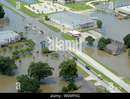 Louisiana Army National Guard Light-Medium and Medium Tactical Vehicles transport flood relief supplies along US 190 in Denham Springs, August 15, 2016, after approximately 30 inches of rainfall inundated portions of Southeast Louisiana beginning Friday, August 12, 2016. Photo by 1st Sgt. Paul Meeker/U.S. Army National Guard/UPI Stock Photo