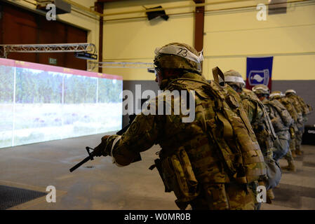U.S. Army Pfc. Shawn Bailey, assigned to the 2nd Calvary Regiment, and fellow U.S. Soldiers from units across U.S. Army Europe fire at virtual targets at the Gunfighter Gymnasium during the 2016 European Best Warrior Competition held at the 7th Army Training Command's Grafenwoehr Training Area, Germany, August 7, 2016. The intense, grueling annual week-long competition is the most prestigious competitive event of the region. Event organizers will announce the year's top junior officer, noncommissioned officer and Soldier during a concluding ceremony scheduled for Aug. 11 at the Grafenwoehr Phy