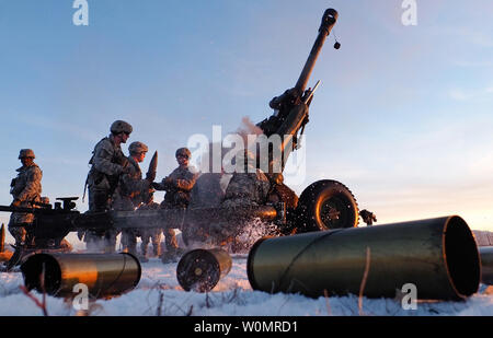 Paratroopers assigned to Alpha Battery, 2nd Battalion, 377th Parachute Field Artillery Regiment, 4th Infantry Brigade Combat Team (Airborne), 25th Infantry Division, U.S. Army Alaska, reload a M119A2 105mm howitzer during a live fire on Malemute drop zone at Joint Base Elmendorf-Richardson, Alaska, November 22, 2016. USARAK is home to the ArmyÕs only Pacific airborne brigade combat team, and maintains the only airborne rapid-response capacity within the Pacific Command Area of Responsibility. Photo by Justin Connaher/U.S. Air Force/UPI Stock Photo