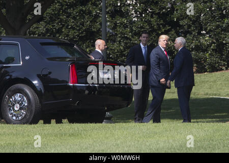 President Donald J. Trump (C) stands near the armored limousine known as 'The Beast', beside US Vice President Mike Pence (R) upon returning from a visit to Federal Emergency Management Agency (FEMA) headquarters, at the South Lawn of the White House in Washington, DC, USA, 04 August 2017. Trump visited FEMA headquarters to receive a briefing on the hurricane season.  Photo by Michael Reynolds/UPI Stock Photo