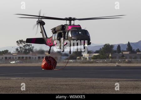 A UH-60 Black Hawk helicopter from the California Army National Guard's B Company, 1st Battalion, 140th Aviation Regiment, lands to refuel at Camarillo Airport in Camarillo, California, on December 9, 2017. The helicopters spent the day dropping water on the Thomas Fire, in coordination with CAL FIRE. By Saturday night, the Thomas Fire had burned 173,000 acres and destroyed over 500 structures since it started December 4. Photo by SrA Crystal Housman/U.S. Air National Guard/UPI Stock Photo