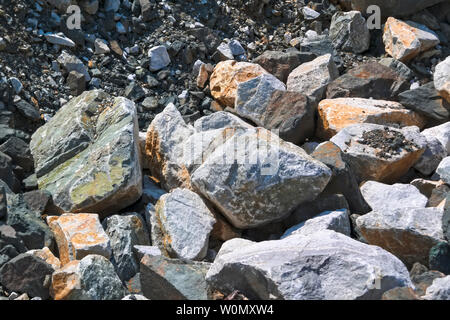Natural texture of stones of large and small size. Danger of rockfalls. Rocks broken into pieces of various sizes. Stock Photo