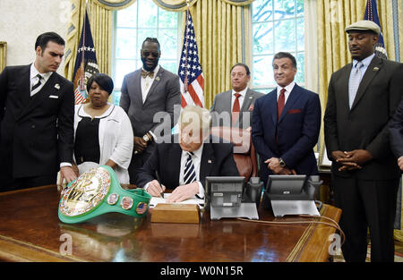US President Donald Trump signs an Executive Grant of Clemency for boxer 'Jack Johnson'  in the Oval Office of the White House on May 24, 2018 in Washington, DC. Photo by Olivier Douliery/UPI Stock Photo